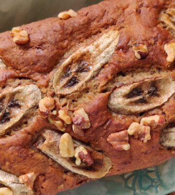 a picture of a chai spiced vegan banana bread loaf topped with sliced bananas