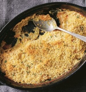 a picture of a vegan cheesy butternut squash and potato bake made with nutritional yeast and vegan bechamel sauce