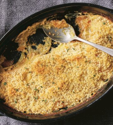 a picture of a vegan cheesy butternut squash and potato bake made with nutritional yeast and vegan bechamel sauce