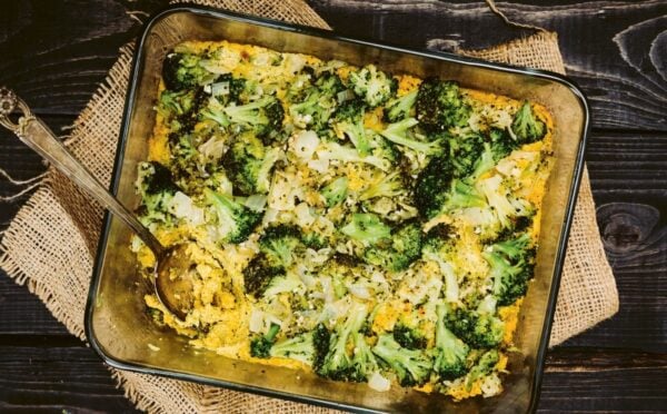 a picture of a vegan cheesy broccoli bake made with silken tofu, nutritional yeast, paprika, and tahini