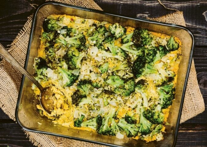 a picture of a vegan cheesy broccoli bake made with silken tofu, nutritional yeast, paprika, and tahini