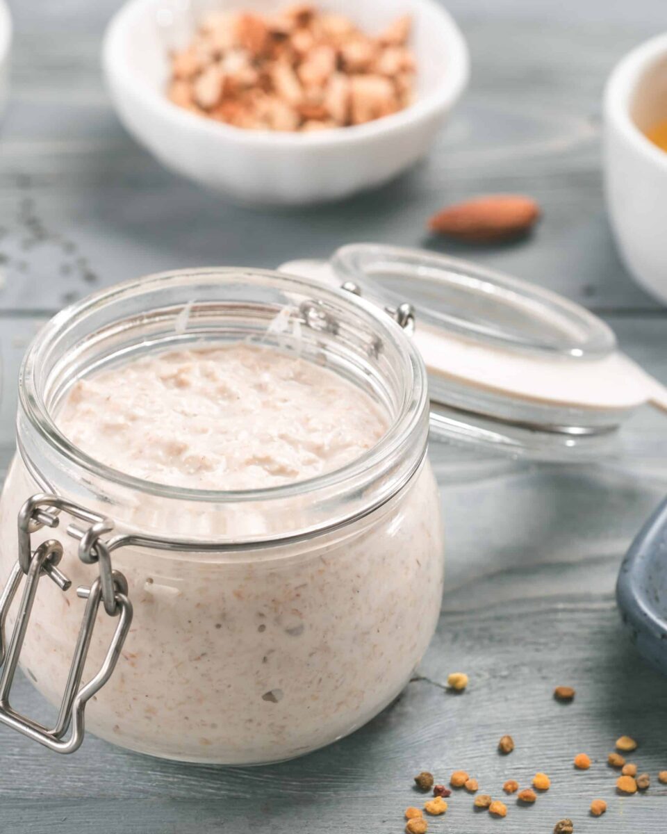 A jar full of vegan overnight oats with chia seeds and maple syrup