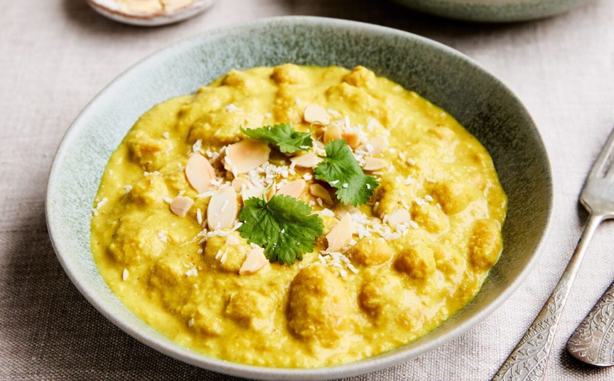 chickpeas and cannellini beans cooked in a coconut milk, carrot, and almond sauce