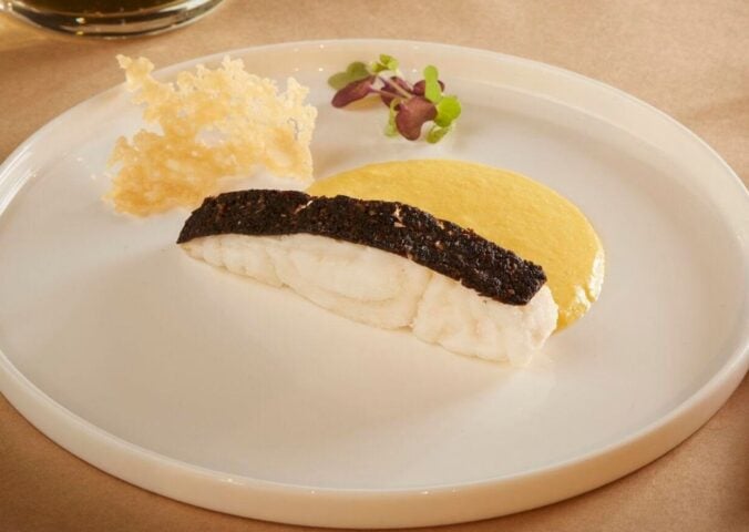 A piece of cultivated fish from UMAMI Bioworks on a white plate