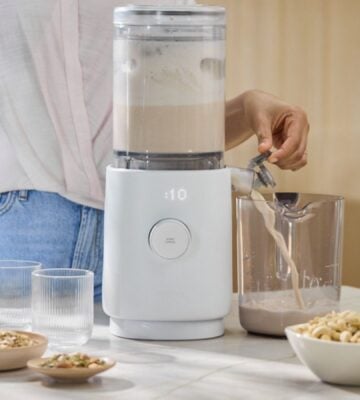 A person making dairy-free milk with the new Nama M1 Plant-Based Milk Maker