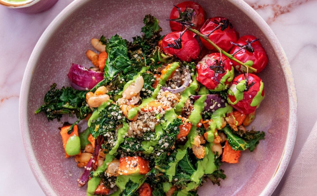 a picture of a kale and sweet potato hash with tomato and beans