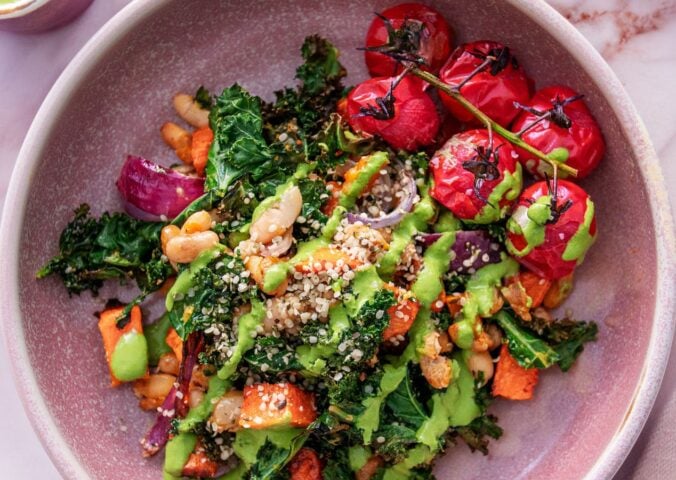 a picture of a kale and sweet potato hash with tomato and beans