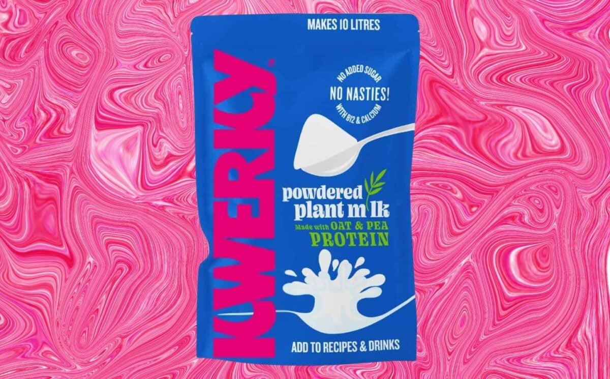 A packet of powdered vegan milk from KWERKY in front of a pink patterned background