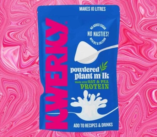 A packet of powdered vegan milk from KWERKY in front of a pink patterned background