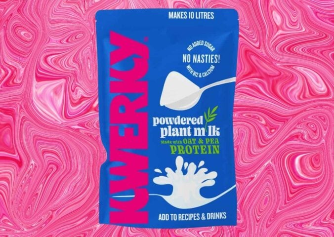 A packet of powdered vegan milk from KWERKY in front of a pink patterned background