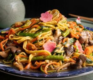 a picture of zucchini noodles paired with vegetables and a tasty sauce