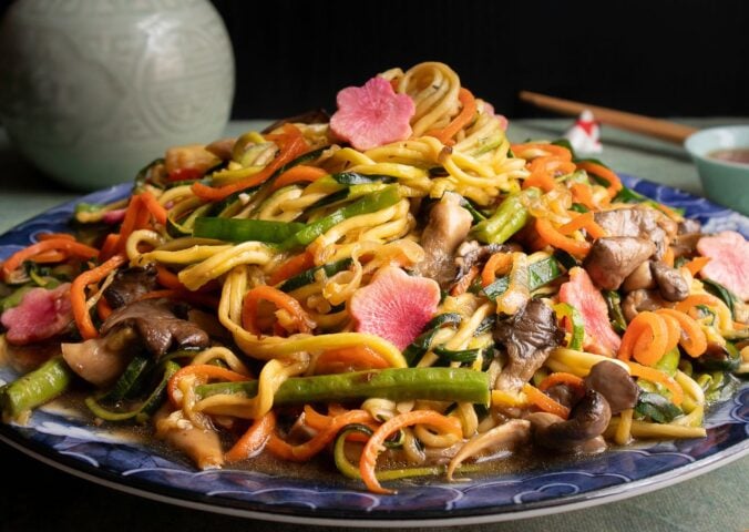 a picture of zucchini noodles paired with vegetables and a tasty sauce