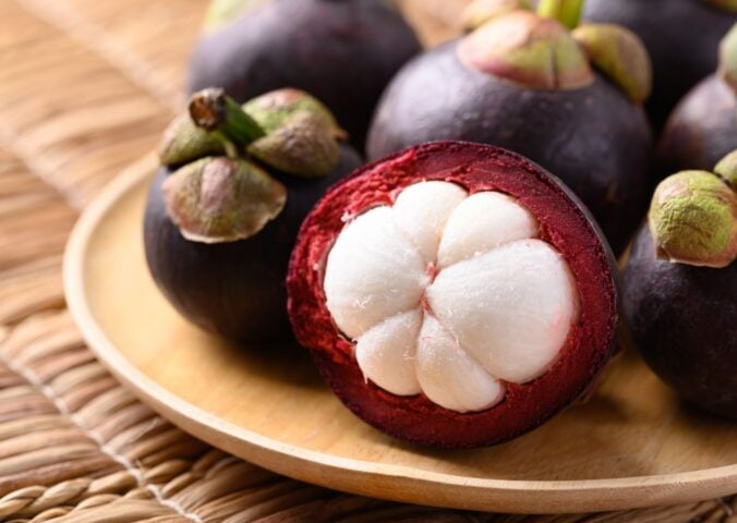 A selection of Mangosteen fruits on a plate