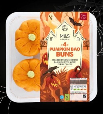 A packet of M&S pumpkin bao buns in front of a black halloween background with cobwebs