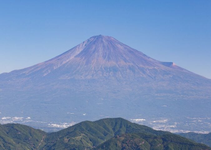 Photo shows the peak and slopes of Japan's Mount Fuji, which are still without their annual snow cap