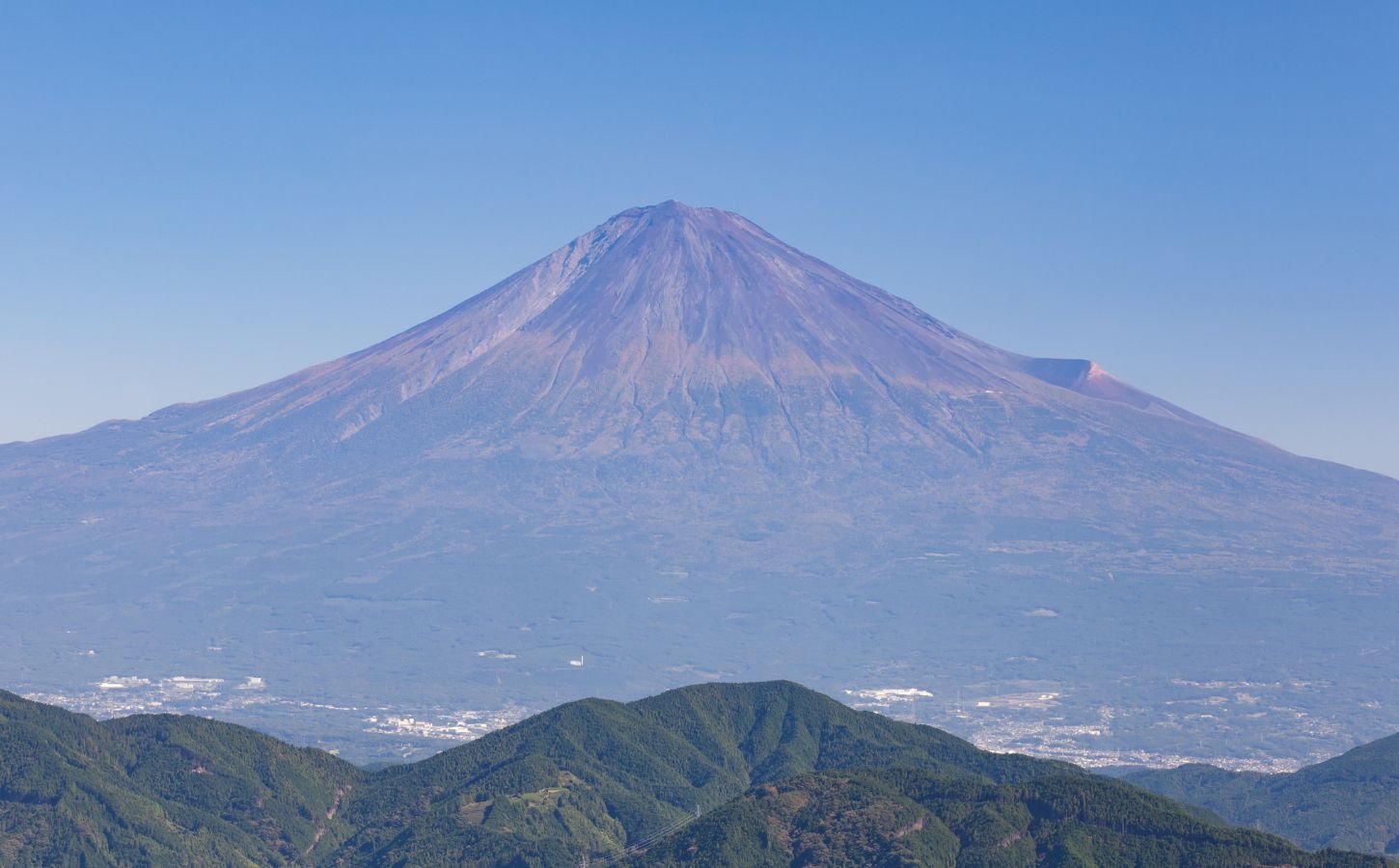 Photo shows the peak and slopes of Japan's Mount Fuji, which are still without their annual snow cap