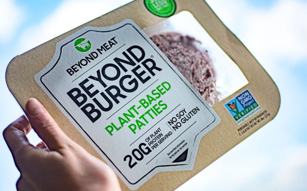 A person holding up a Beyond Burger to the sky