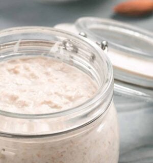 A jar full of vegan overnight oats with chia seeds and maple syrup