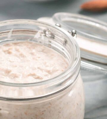 A jar full of vegan overnight oats with chia seeds and maple syrup