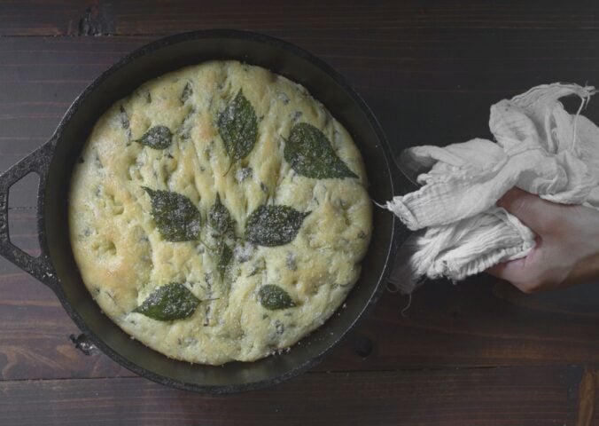 a picture of a perilla leaf focaccia in a cast iron skillet