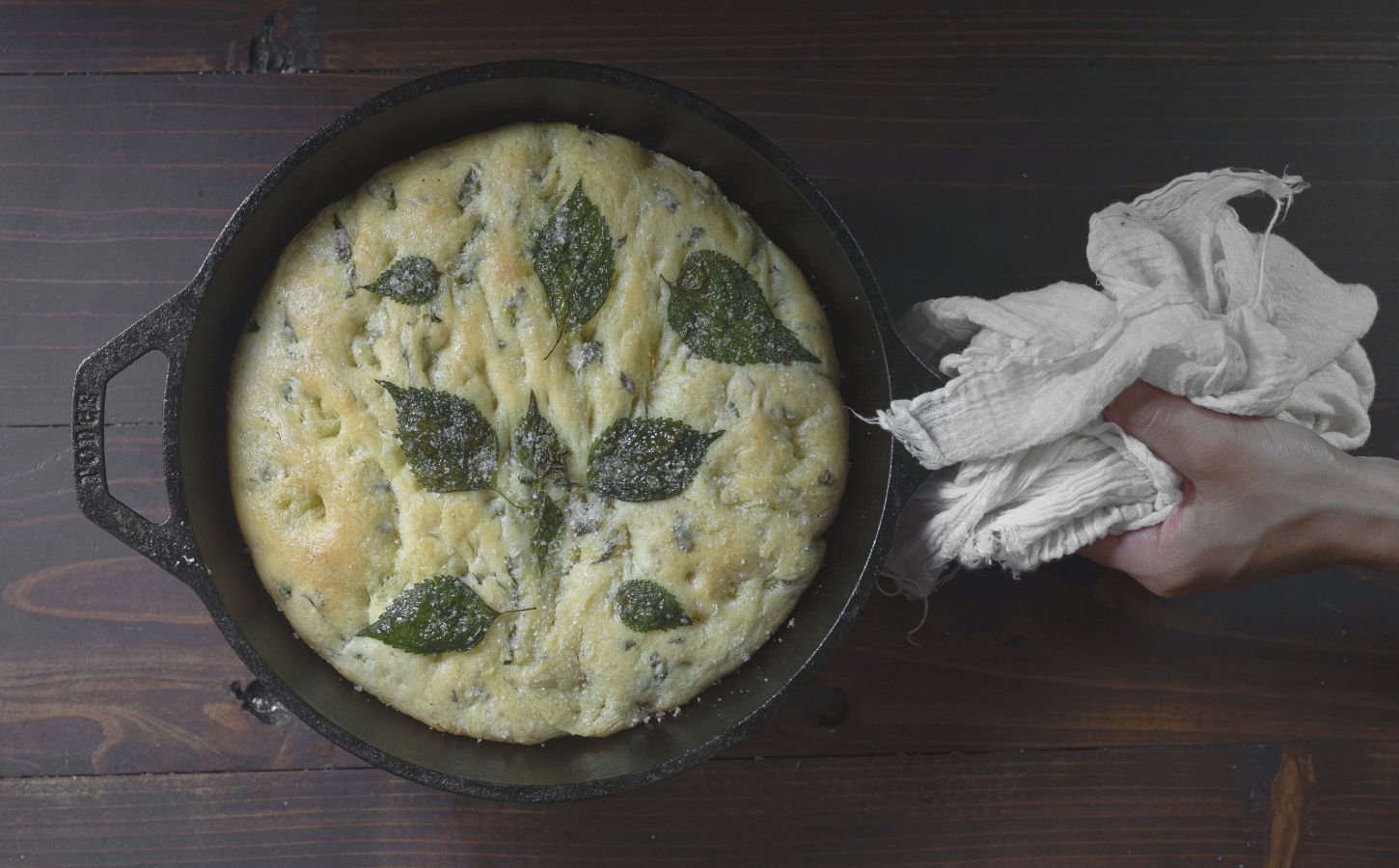 a picture of a perilla leaf focaccia in a cast iron skillet