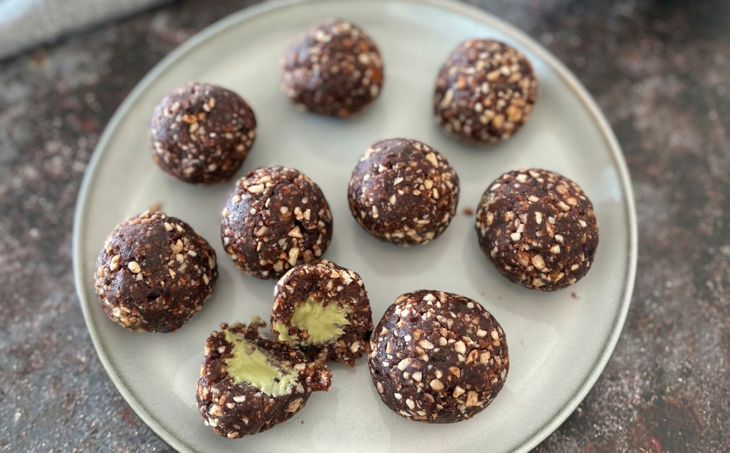 A plate of pistachio energy balls made to a vegan recipe