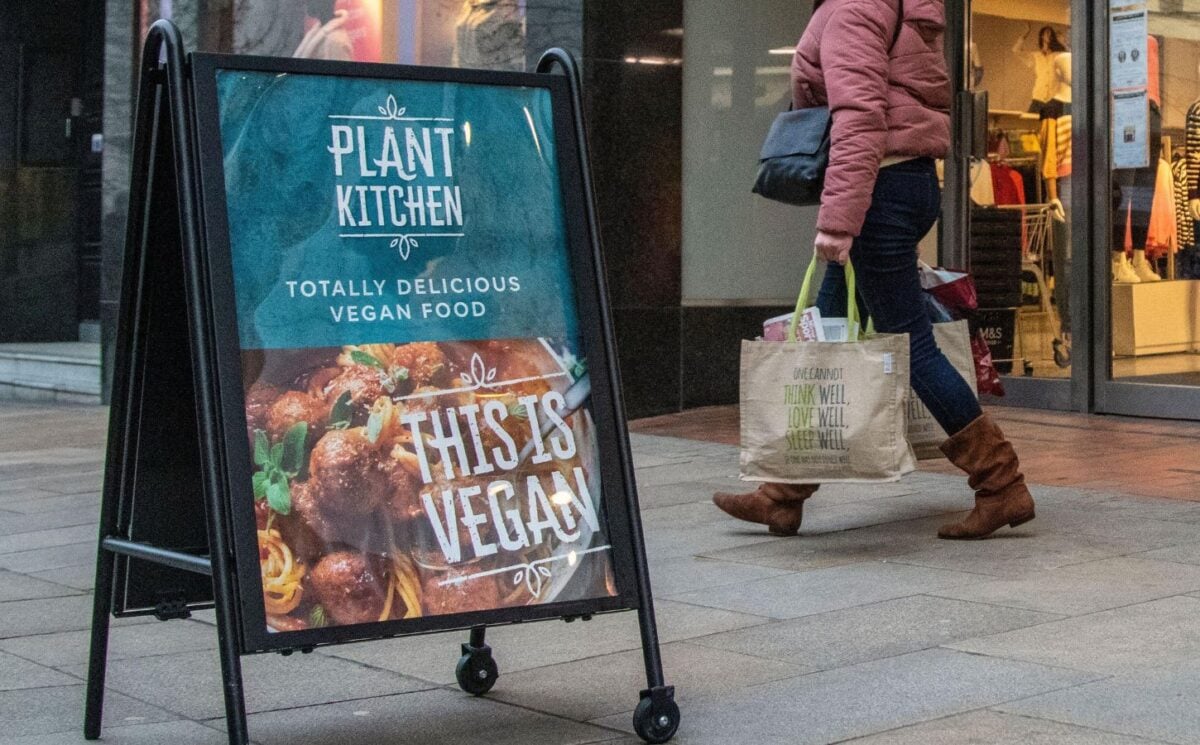 A sign outside M&S advertising its Plant Kitchen range reading "This is vegan"