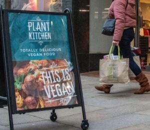 A sign outside M&S advertising its Plant Kitchen range reading "This is vegan"