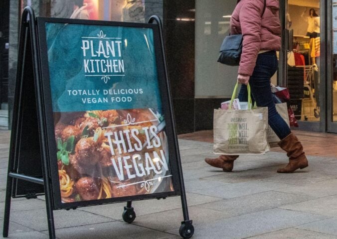 A sign outside M&S advertising its Plant Kitchen range reading "This is vegan"