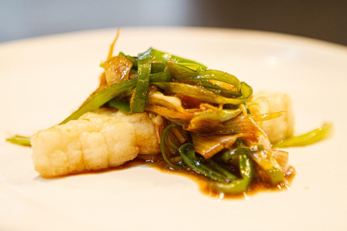 A piece of cultivated fish from UMAMI Bioworks on a white plate