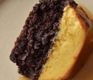 A picture of a slice of vegan chocoflan made with silken tofu and box cake mix