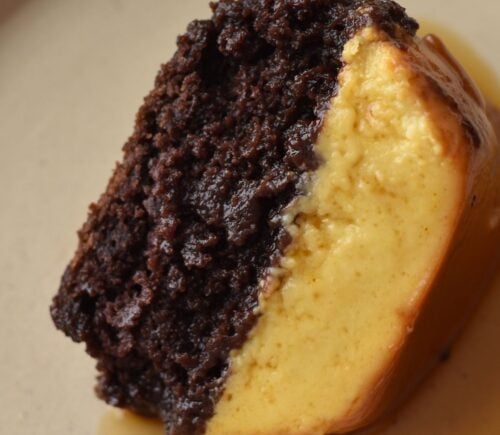 A picture of a slice of vegan chocoflan made with silken tofu and box cake mix