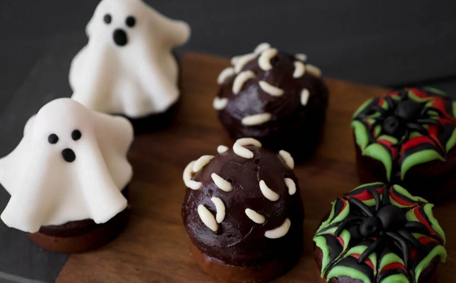 a picture of a vegan Halloween cupcake recipe with ghosts, spiders, etc. as decoration