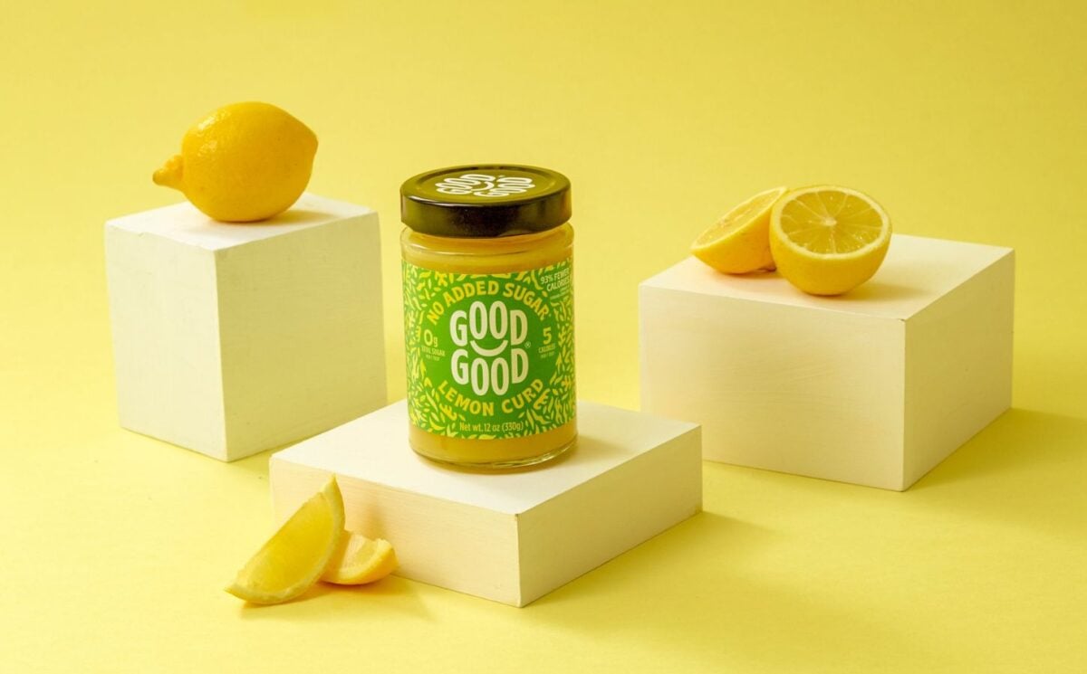 Photo shows GOOD GOOD's vegan lemon curd product, surrounded by lemons, against a yellow background