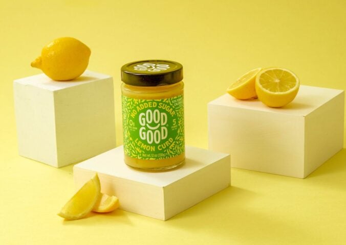 Photo shows GOOD GOOD's vegan lemon curd product, surrounded by lemons, against a yellow background