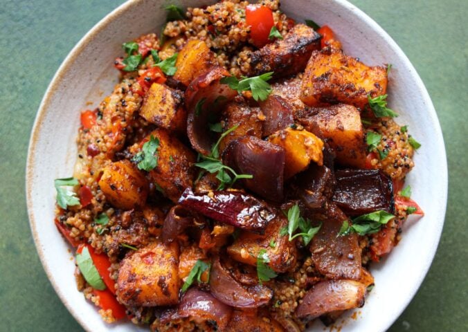 a picture of a speedy squash bowl with butternut, quinoa, tomato, harissa, onion, and red pepper that makes part of the vegan lunches to make in October