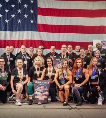 The all-vegan Vegan Strong Plantbuilt team in front of a huge US flat competing at Mr. America