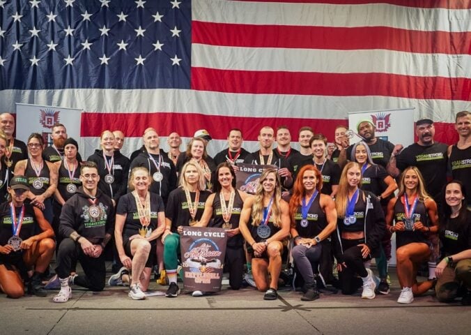 The all-vegan Vegan Strong Plantbuilt team in front of a huge US flat competing at Mr. America