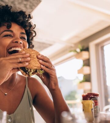 Woman eats burger