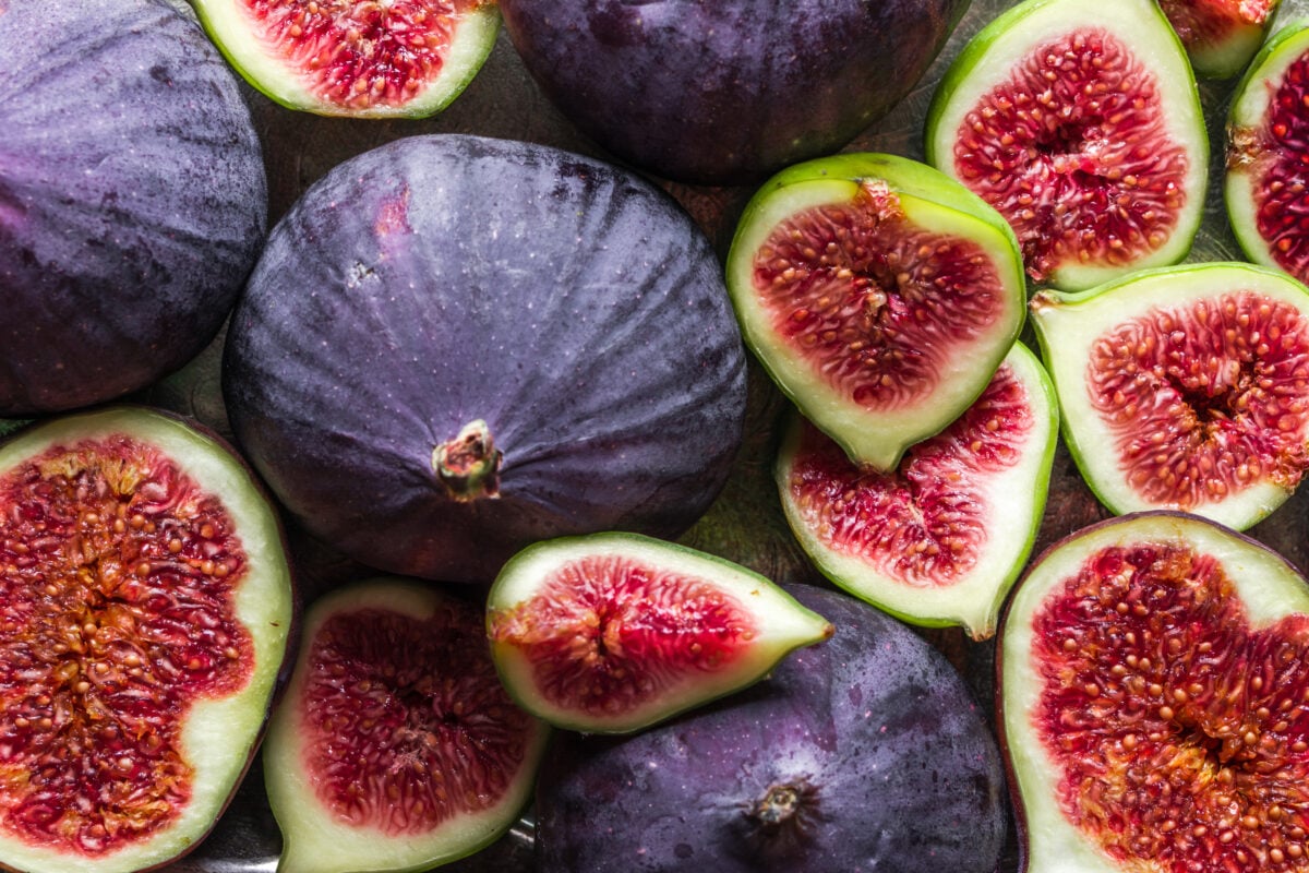 Photo shows a selection of whole and halved fresh figs