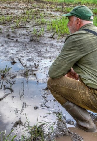 Farmer in waterlogged field