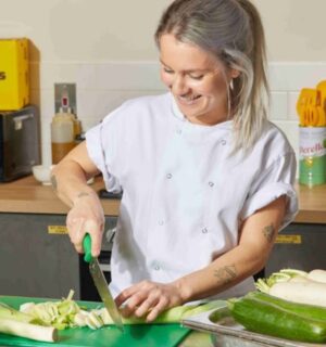 Photo shows Allplants Development Kitchen Assistant Mimi preparing vegetables