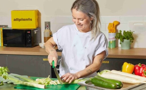 Photo shows Allplants Development Kitchen Assistant Mimi preparing vegetables