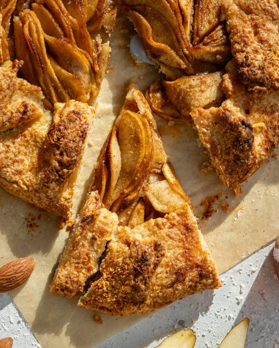 a close-up of the almond pear galette sliced showing the detail of the pears and pastry