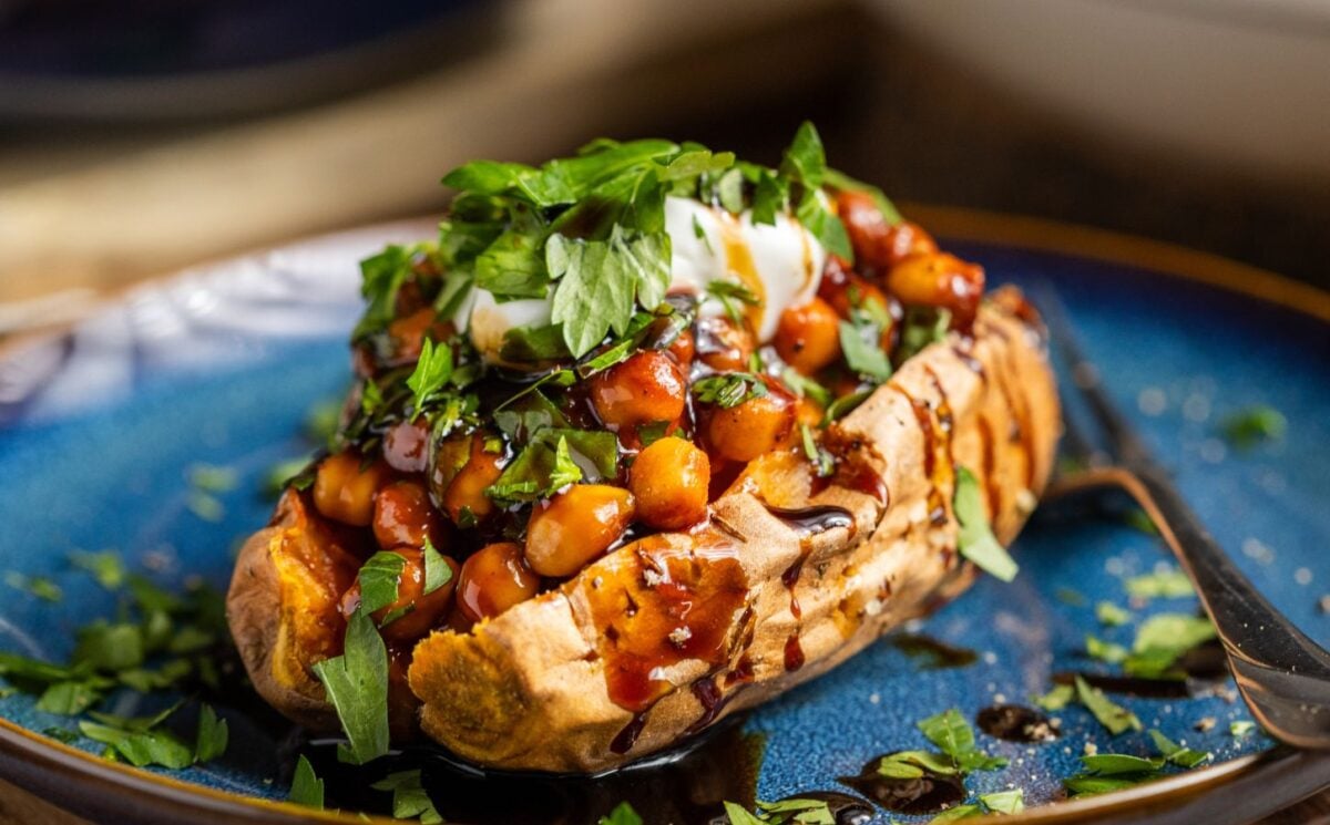 buffalo chickpeas on roasted sweet potato topped with coriander and coconut yogurt