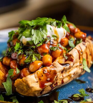 buffalo chickpeas on roasted sweet potato topped with coriander and coconut yogurt