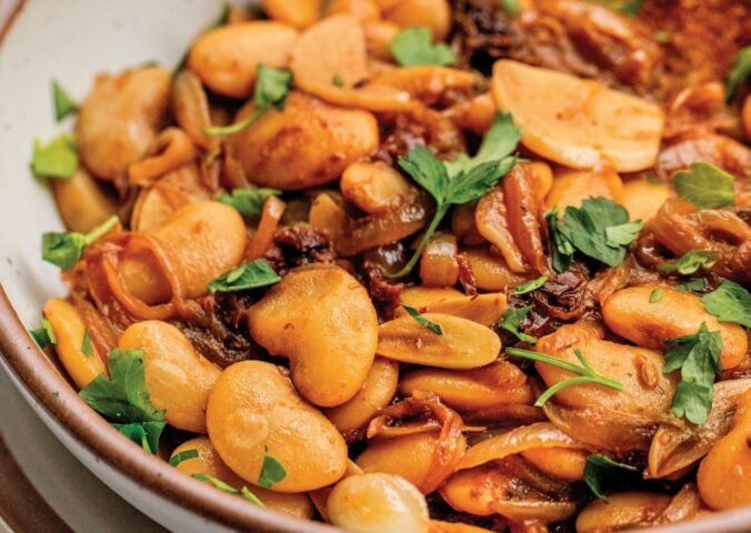 a bowl of caramelized onion butter beans made with sun-dried tomatoes and jammy onions