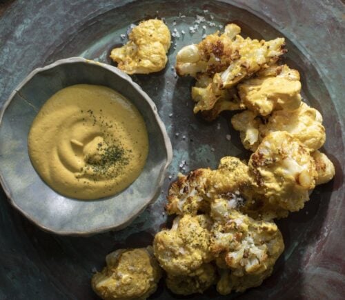 a picture of coliflor frito or crispy cauliflower served with cashew nacho cheese