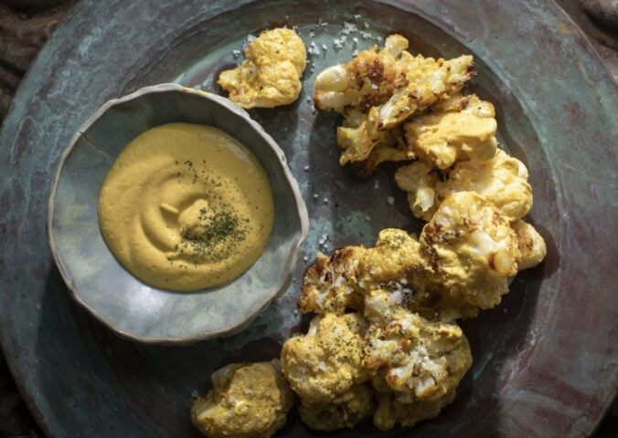 a picture of coliflor frito or crispy cauliflower served with cashew nacho cheese