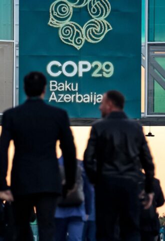 Men walking into the COP29 conference in Baku, Azerbaijan